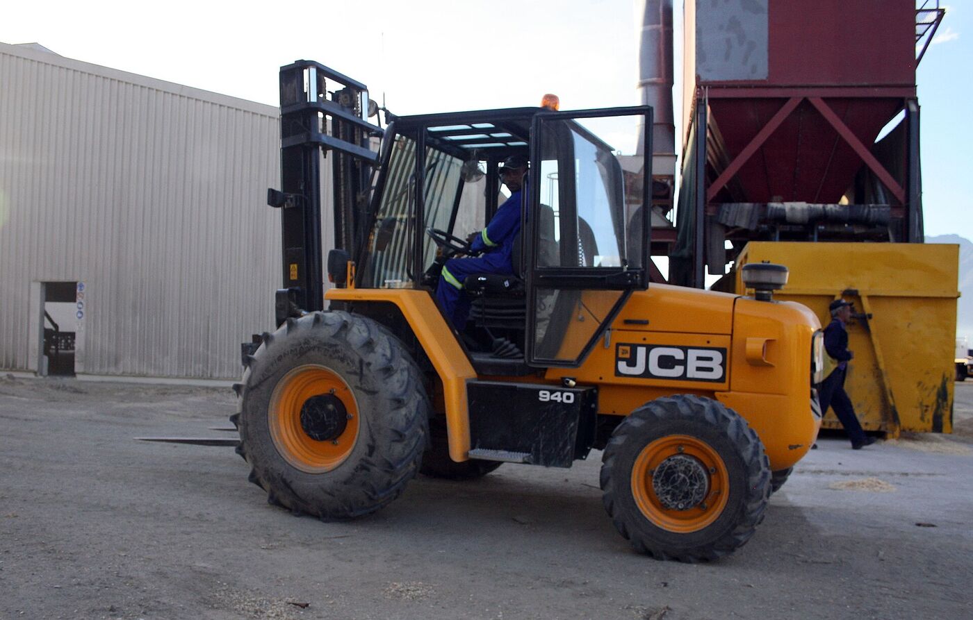 A rough terrain forklift with large tyres working on a construction site