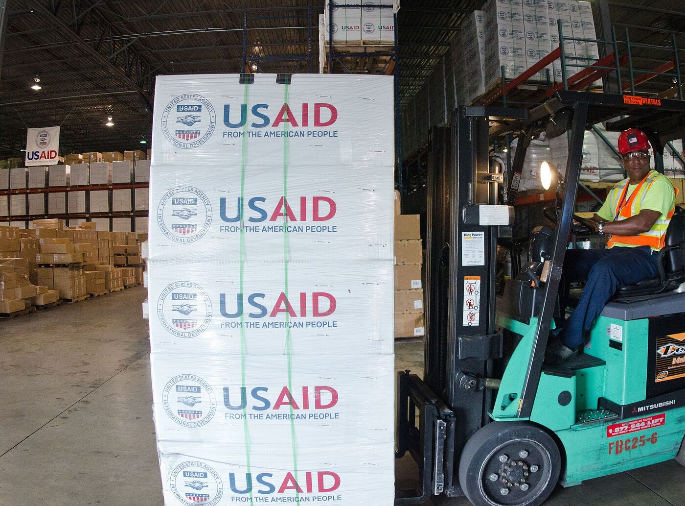 Forklifts working in a busy warehouse with marked floor routes