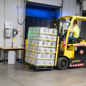 man riding on yellow forklift