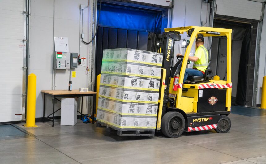 man riding on yellow forklift